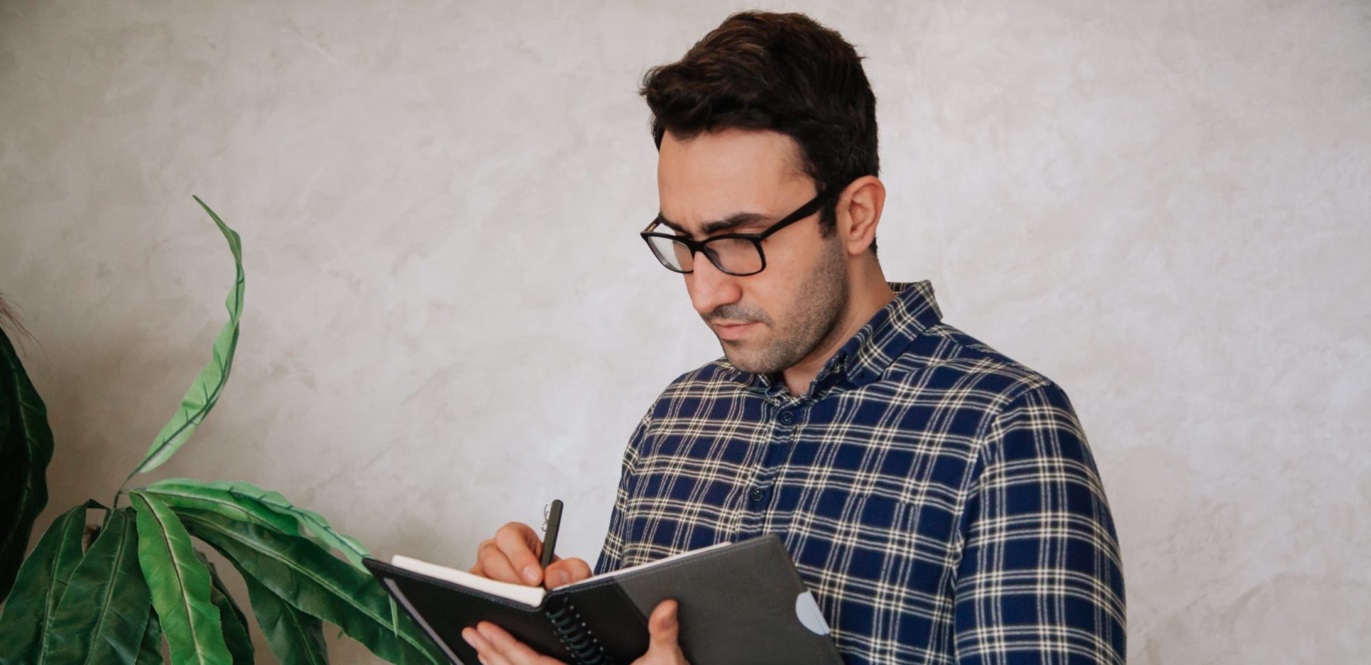 Man writing on a Ipad